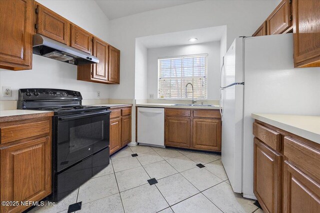 kitchen with sink, white appliances, and light tile patterned floors