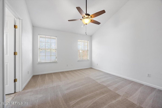 empty room with vaulted ceiling, light carpet, and ceiling fan