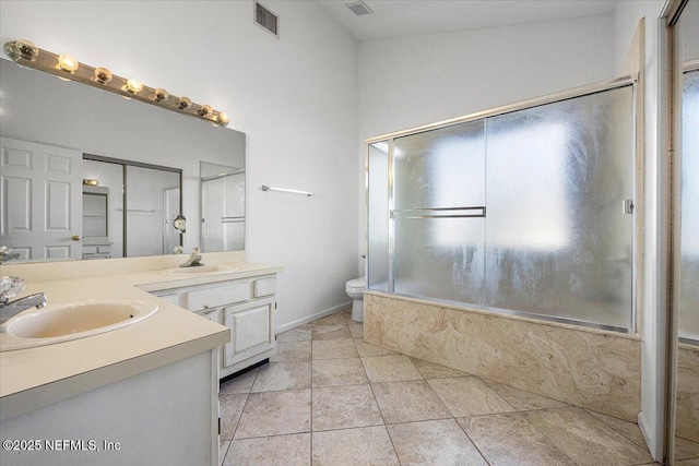 full bathroom with tile patterned flooring, bathing tub / shower combination, vanity, and toilet