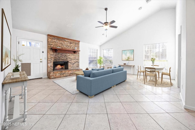 tiled living room with a fireplace, high vaulted ceiling, and ceiling fan