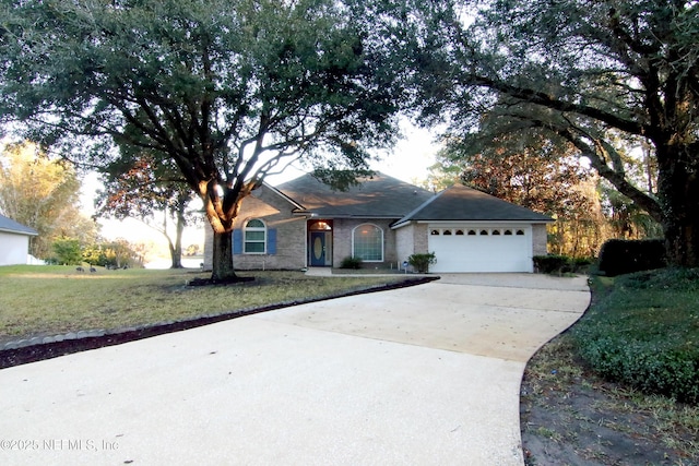 ranch-style home featuring a front lawn and a garage