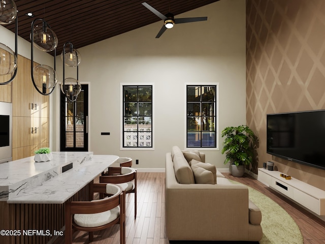 living room featuring hardwood / wood-style flooring, high vaulted ceiling, ceiling fan, and wood ceiling