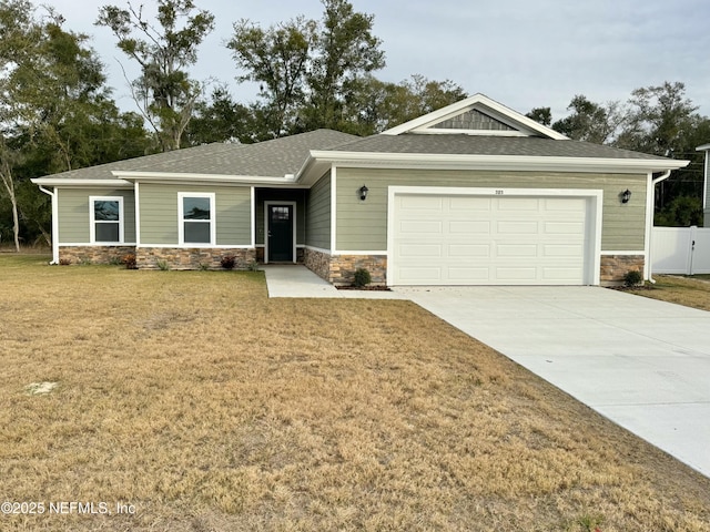 view of front of home with a garage and a front lawn