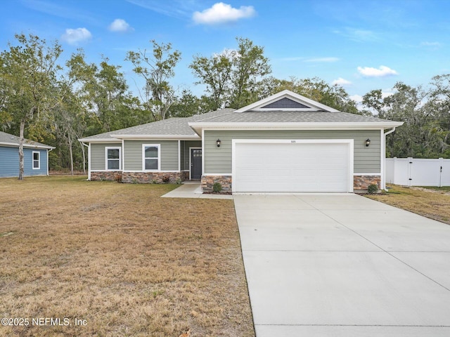 view of front of home featuring a garage and a front lawn