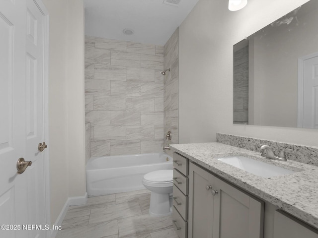 full bathroom with toilet, vanity, and tiled shower / bath