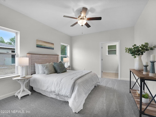 bedroom with ceiling fan, carpet, and multiple windows