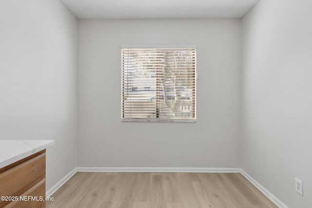 empty room with light hardwood / wood-style flooring