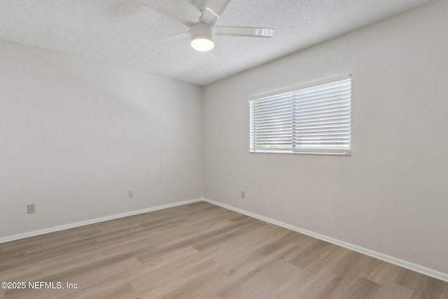 empty room featuring ceiling fan, a textured ceiling, and light hardwood / wood-style flooring