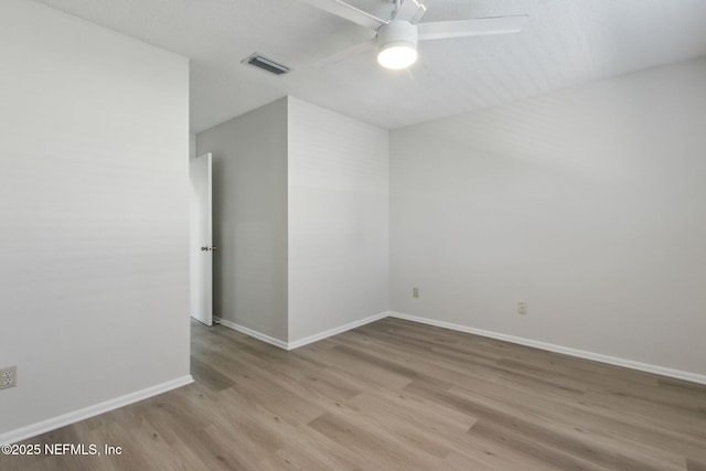 empty room featuring ceiling fan and light hardwood / wood-style flooring