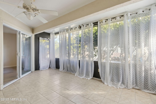 unfurnished sunroom with ceiling fan and plenty of natural light