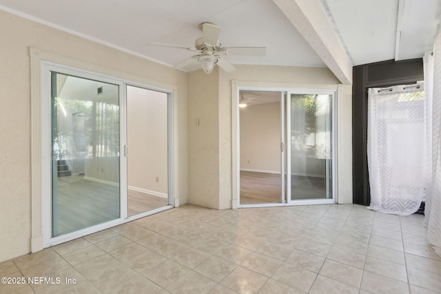 unfurnished sunroom with ceiling fan