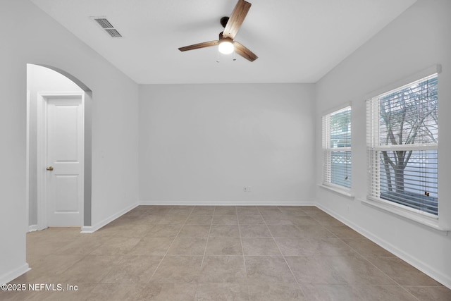 tiled empty room with ceiling fan