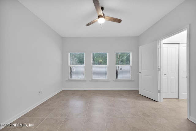 unfurnished room with ceiling fan and light tile patterned floors