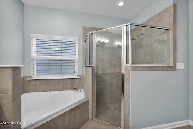 bathroom featuring plus walk in shower and a textured ceiling