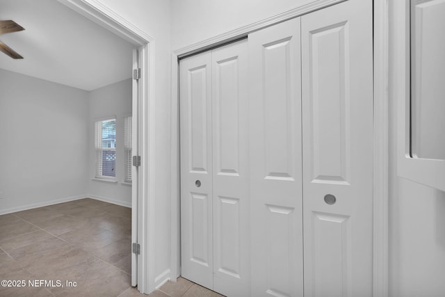 hall featuring light tile patterned flooring