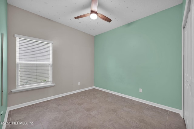 spare room with ceiling fan