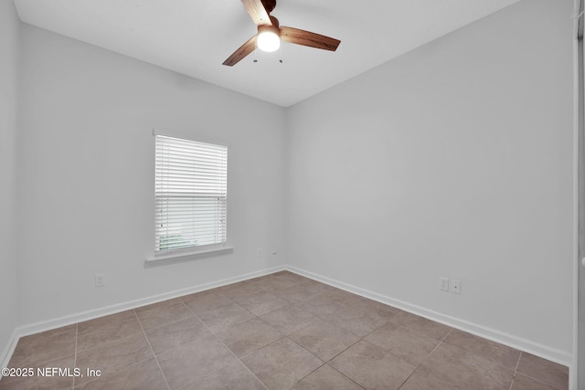 spare room featuring light tile patterned flooring and ceiling fan