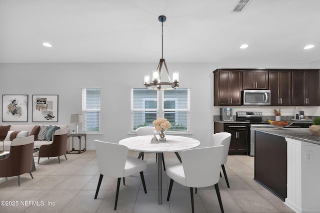 kitchen featuring pendant lighting, light tile patterned floors, a notable chandelier, dark brown cabinetry, and stainless steel appliances