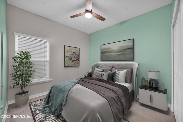 bedroom featuring ceiling fan and light tile patterned floors