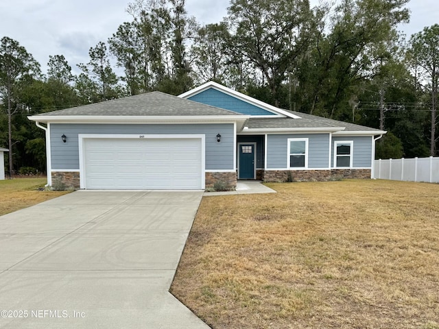 view of front of home featuring a front yard and a garage