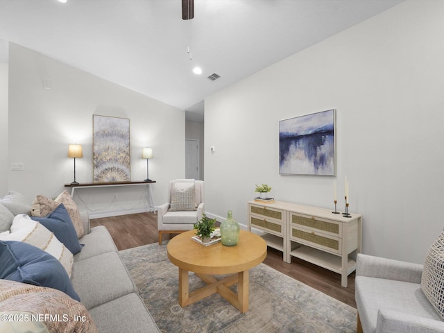 living room featuring ceiling fan, lofted ceiling, and dark hardwood / wood-style floors