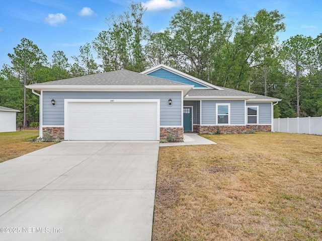 view of front of house with a garage and a front lawn