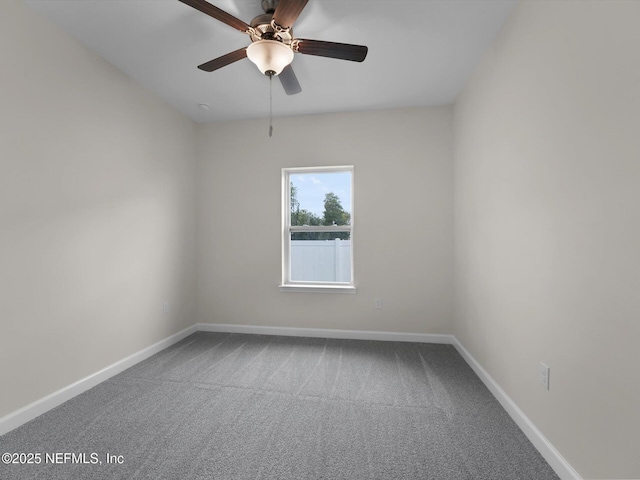 spare room with ceiling fan and carpet