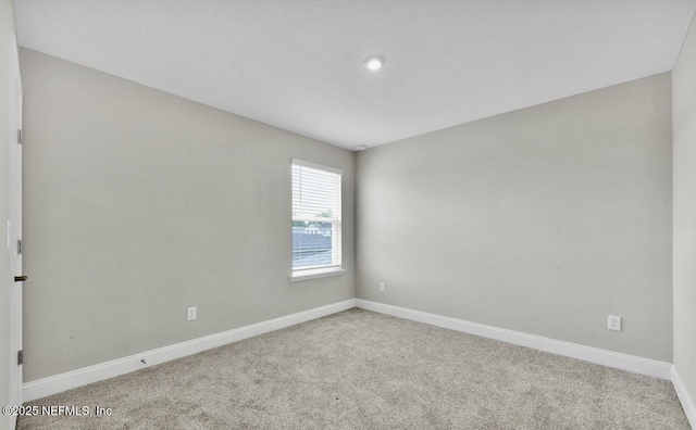 spare room with light colored carpet