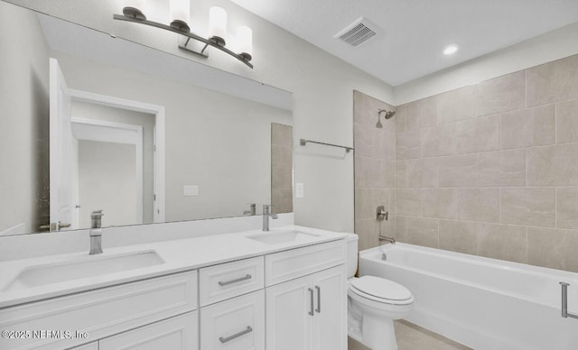 full bathroom with vanity, toilet, and tiled shower / bath