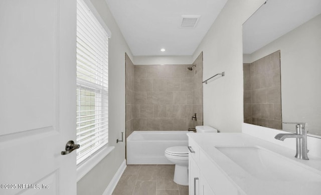 full bathroom featuring tile patterned floors, toilet, vanity, and a wealth of natural light