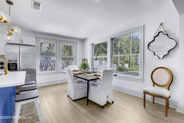 dining space with light hardwood / wood-style flooring