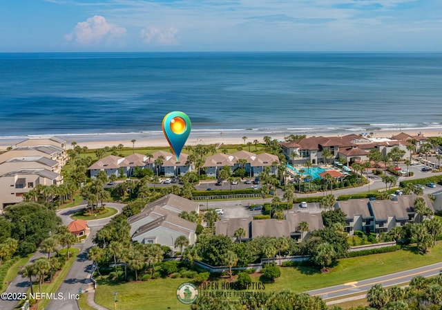 birds eye view of property with a beach view and a water view