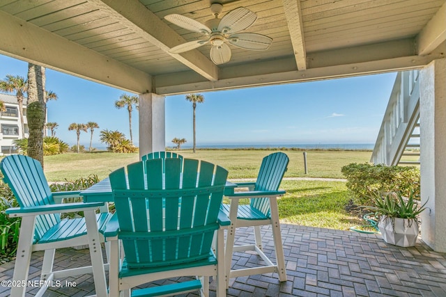 view of patio / terrace with ceiling fan and a rural view