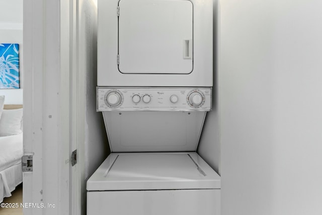 laundry area with stacked washer and dryer