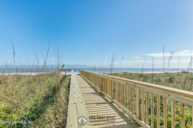 view of home's community with a beach view and a water view