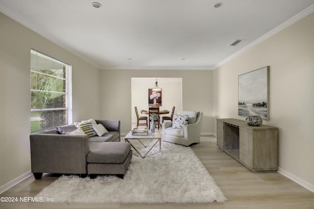 living room featuring ornamental molding and light hardwood / wood-style floors