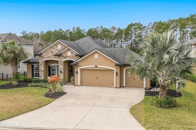 view of front of home featuring a garage and a front lawn