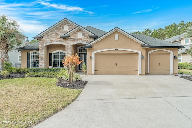 view of front facade with a front yard and a garage