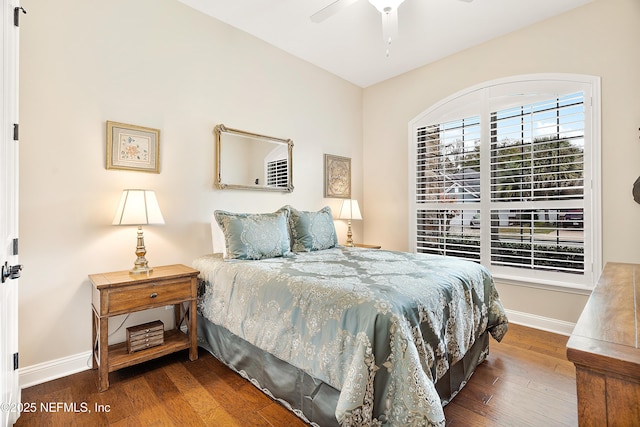 bedroom with ceiling fan and dark hardwood / wood-style floors