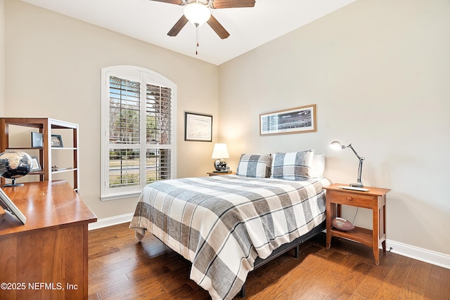 bedroom featuring multiple windows, ceiling fan, and dark hardwood / wood-style floors