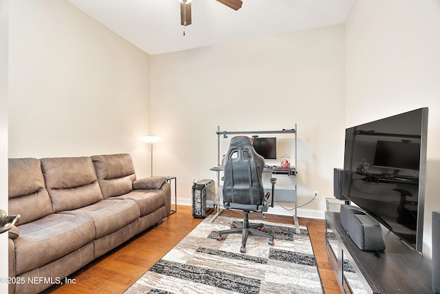 living room featuring ceiling fan and light hardwood / wood-style floors