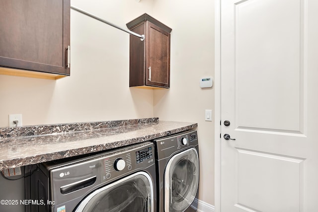 clothes washing area with cabinets and independent washer and dryer