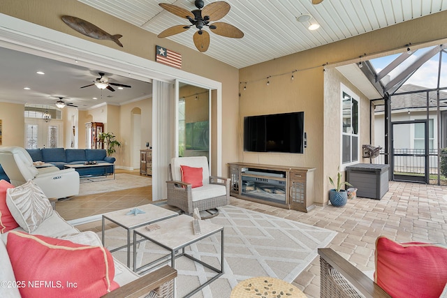 living room with a fireplace and crown molding