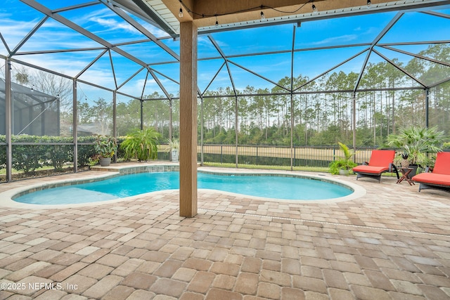 view of pool featuring a patio area and glass enclosure