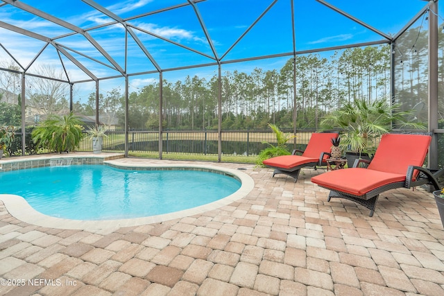 view of swimming pool with a patio and glass enclosure