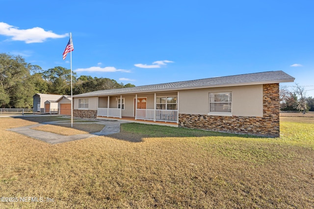 single story home featuring a front yard and covered porch