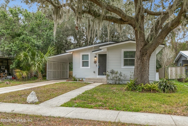 view of front of house featuring a front yard and a carport