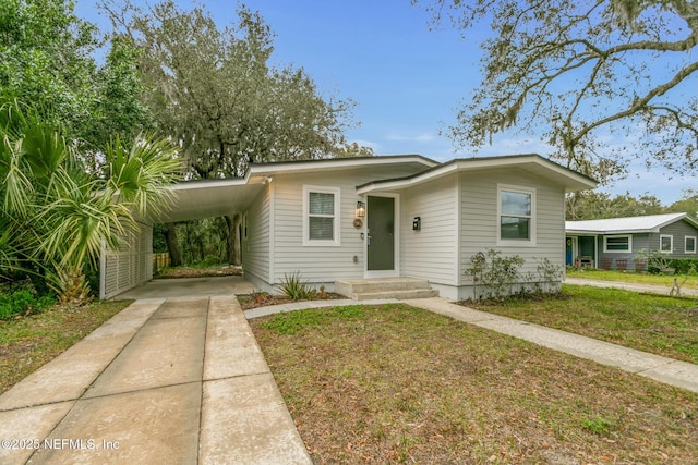 bungalow featuring a front yard and a carport