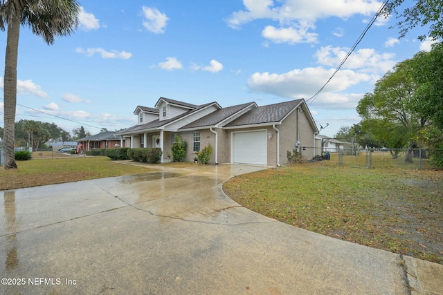 view of front of home featuring a front yard and a garage