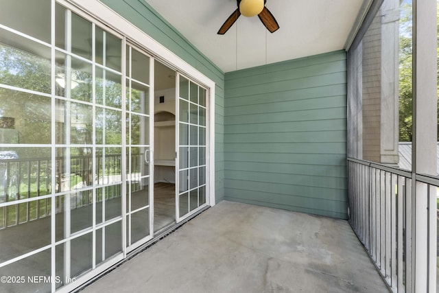 unfurnished sunroom with ceiling fan